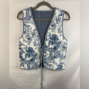 Blue china print quilted vest with striped edges and lining. With a tie front.